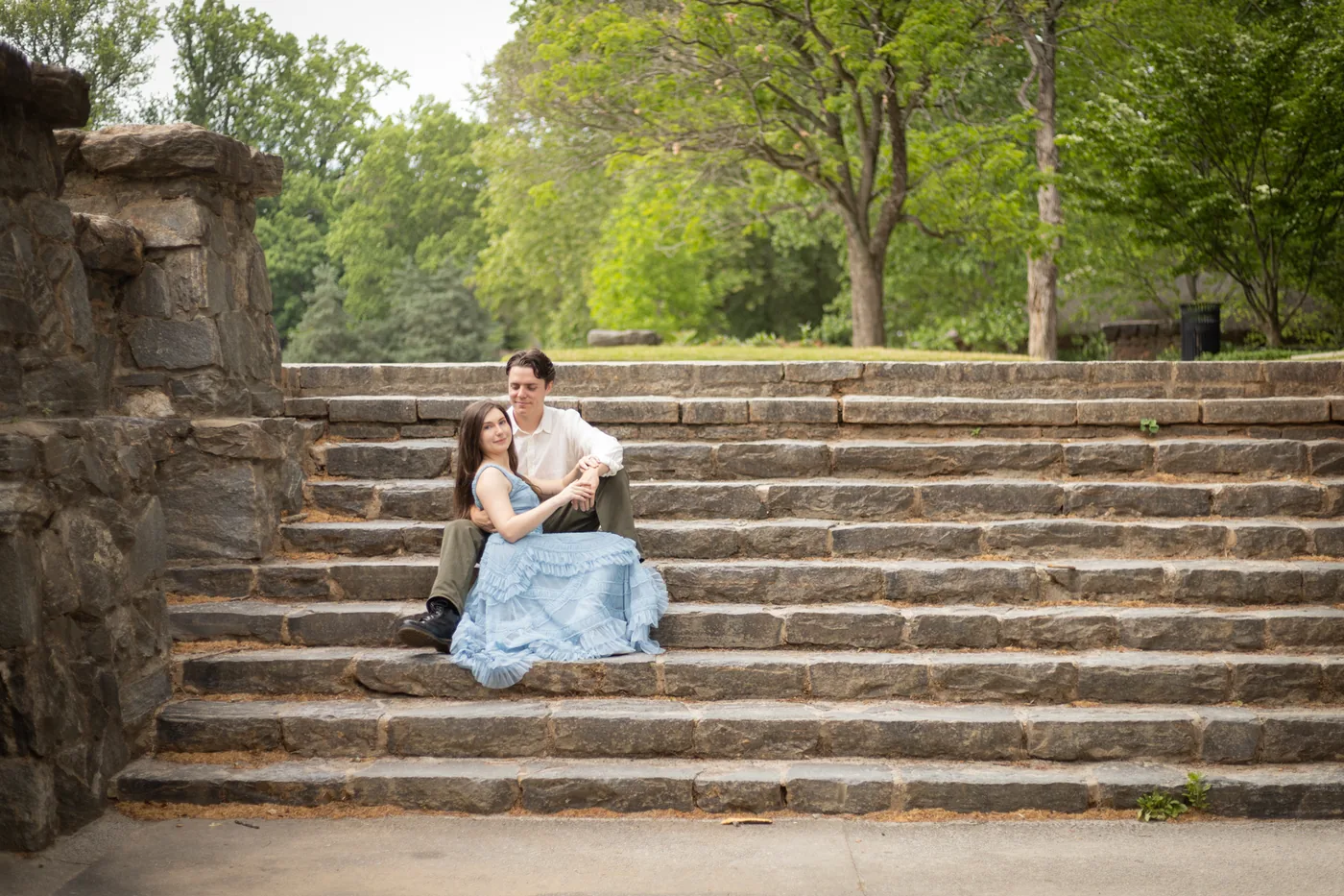 Alyse and Andrew seated on stone steps