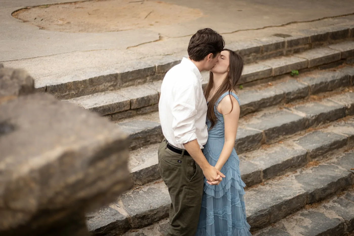 Alyse and Andrew kissing on stone steps