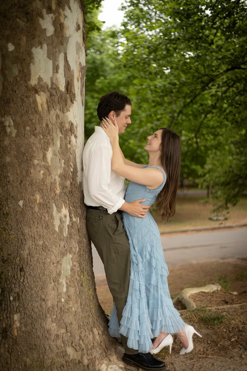 Alyse and Andrew leaning against a tree